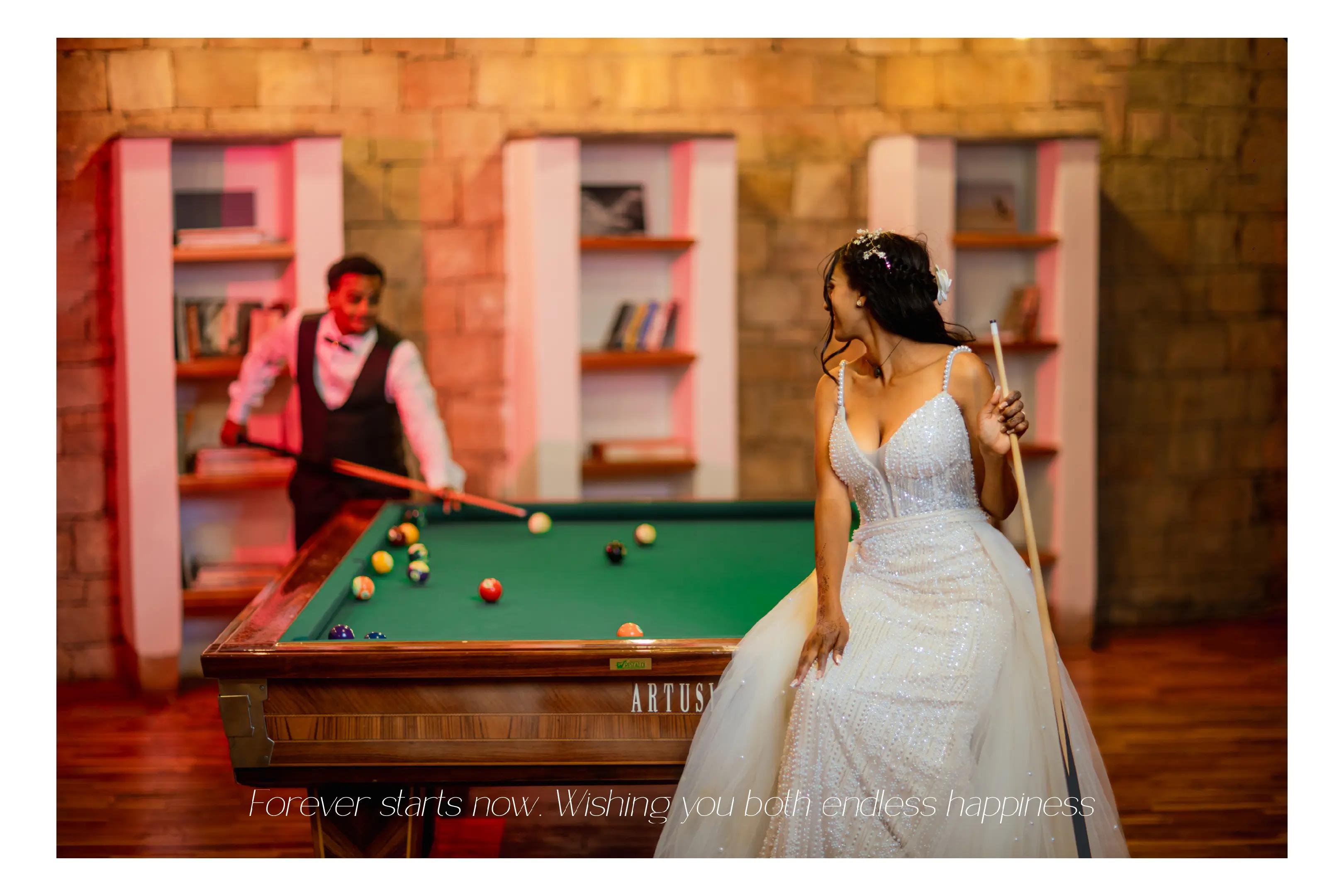 Bride and groom playful billiard table wedding portrait